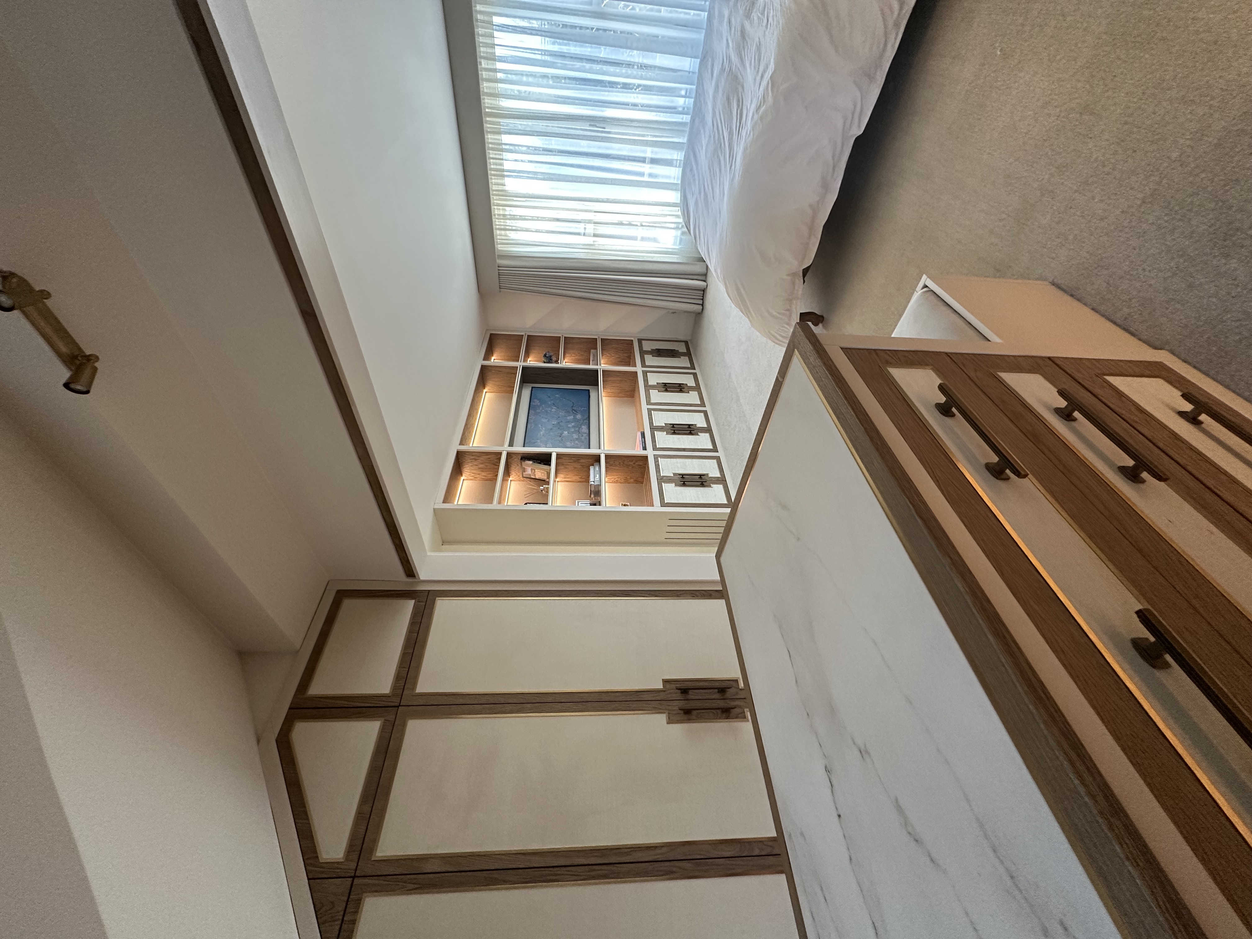 Fitted bedroom suite detail — cream joinery and brass inlay Manchester by Hafferty Interiors
