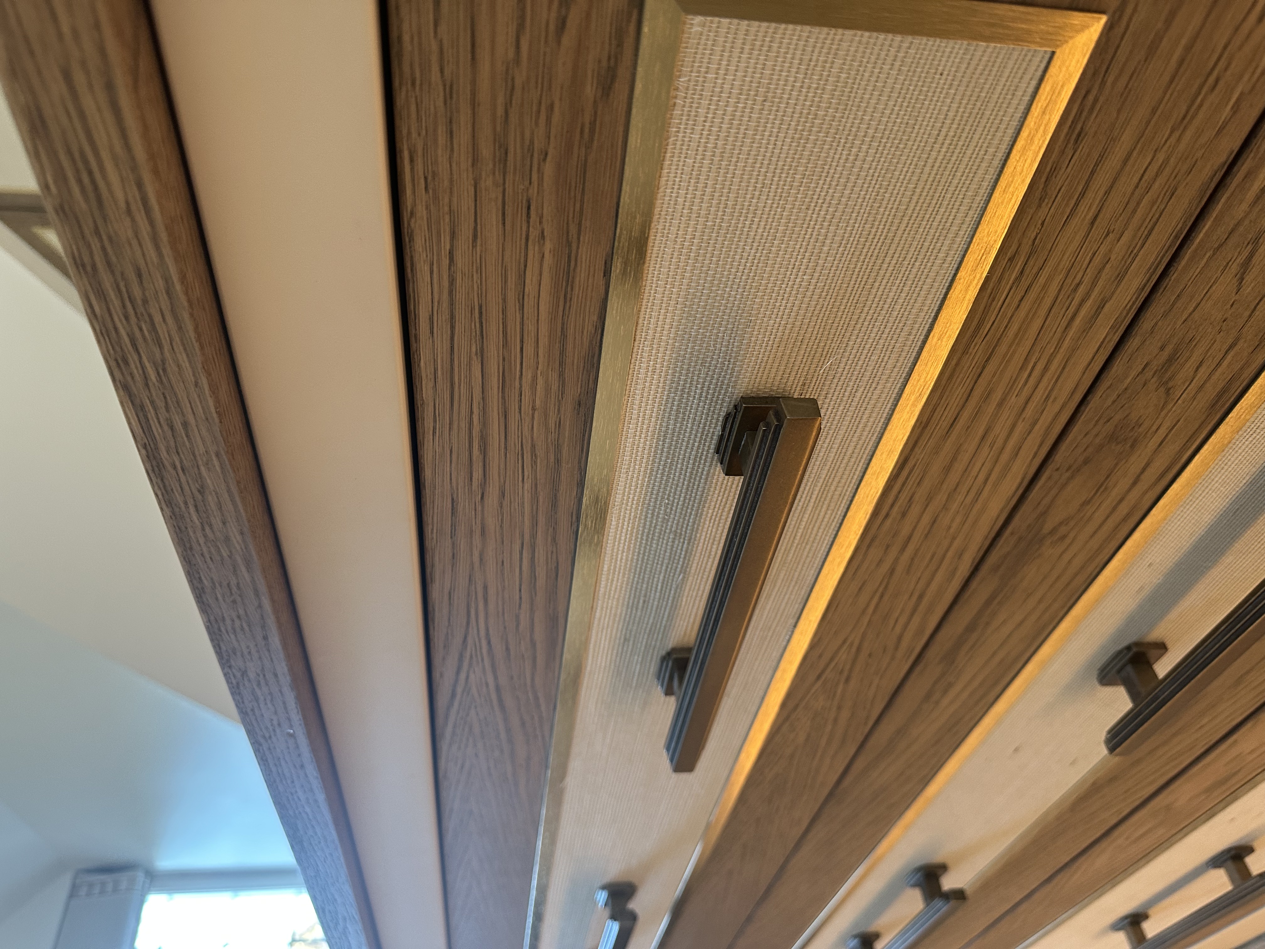 Brass inlay and textured wallpaper drawer detail — bespoke fitted bedroom Manchester by Hafferty Interiors
