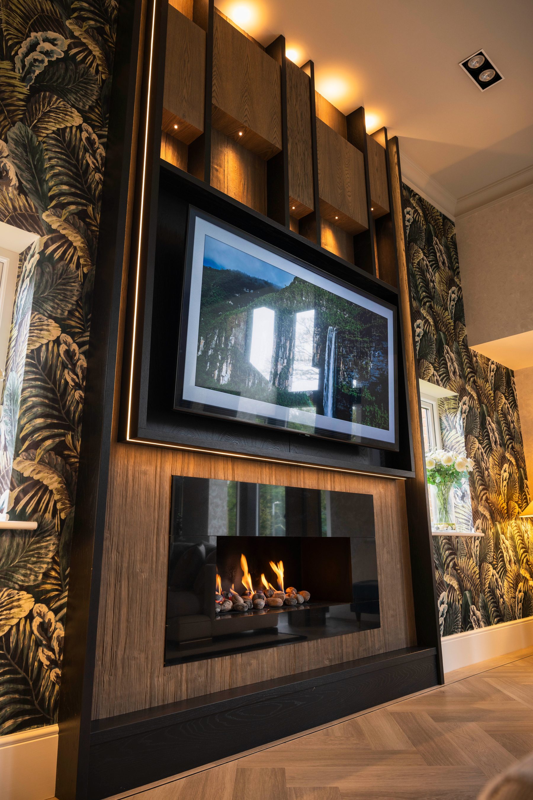 Bespoke oak media wall with miniature recessed spotlights and Arte botanical wallpaper — Hafferty Interiors