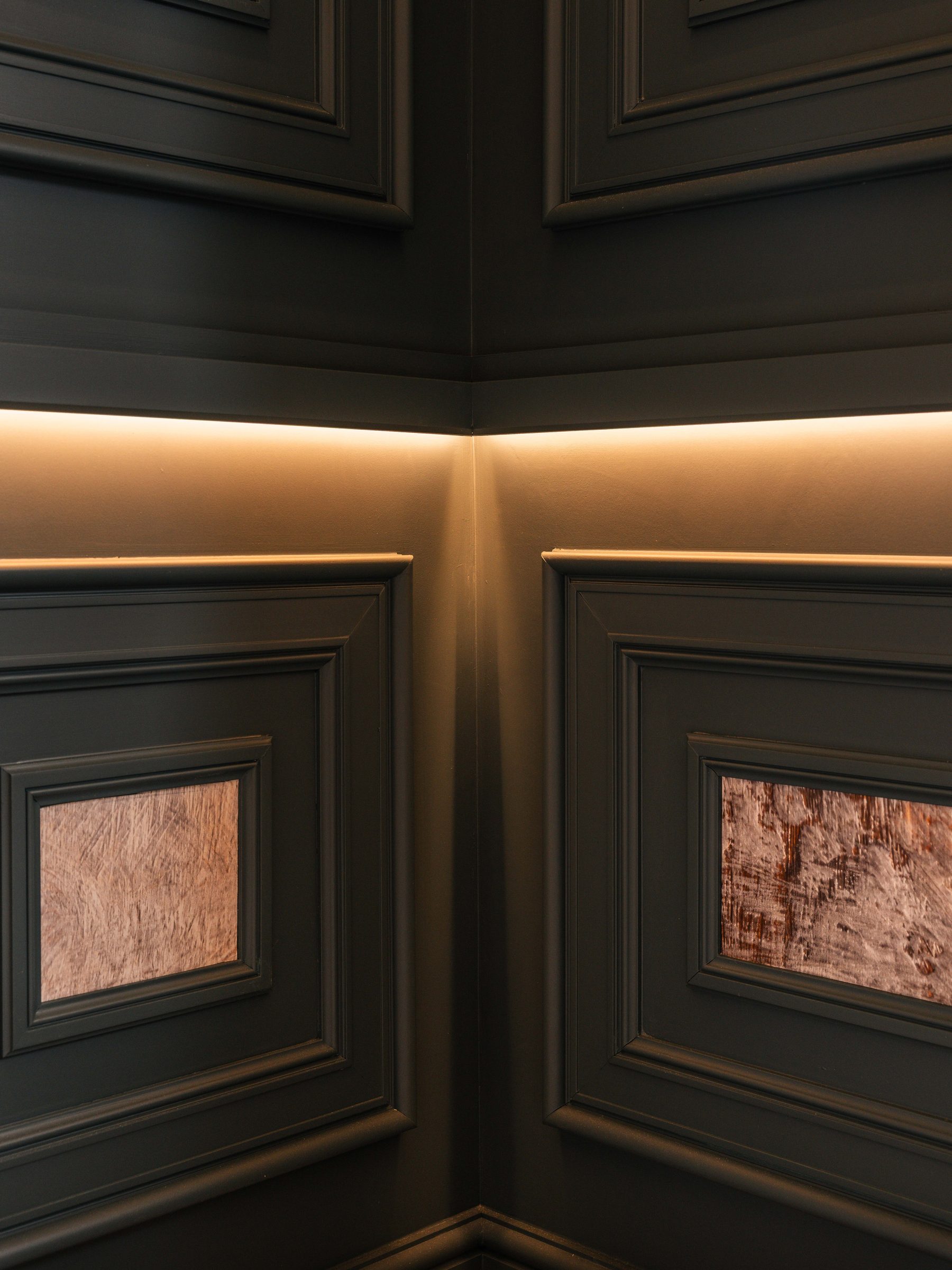 Concealed warm LED lighting at panel junction detail — bespoke living room Boothstown by Hafferty Interiors