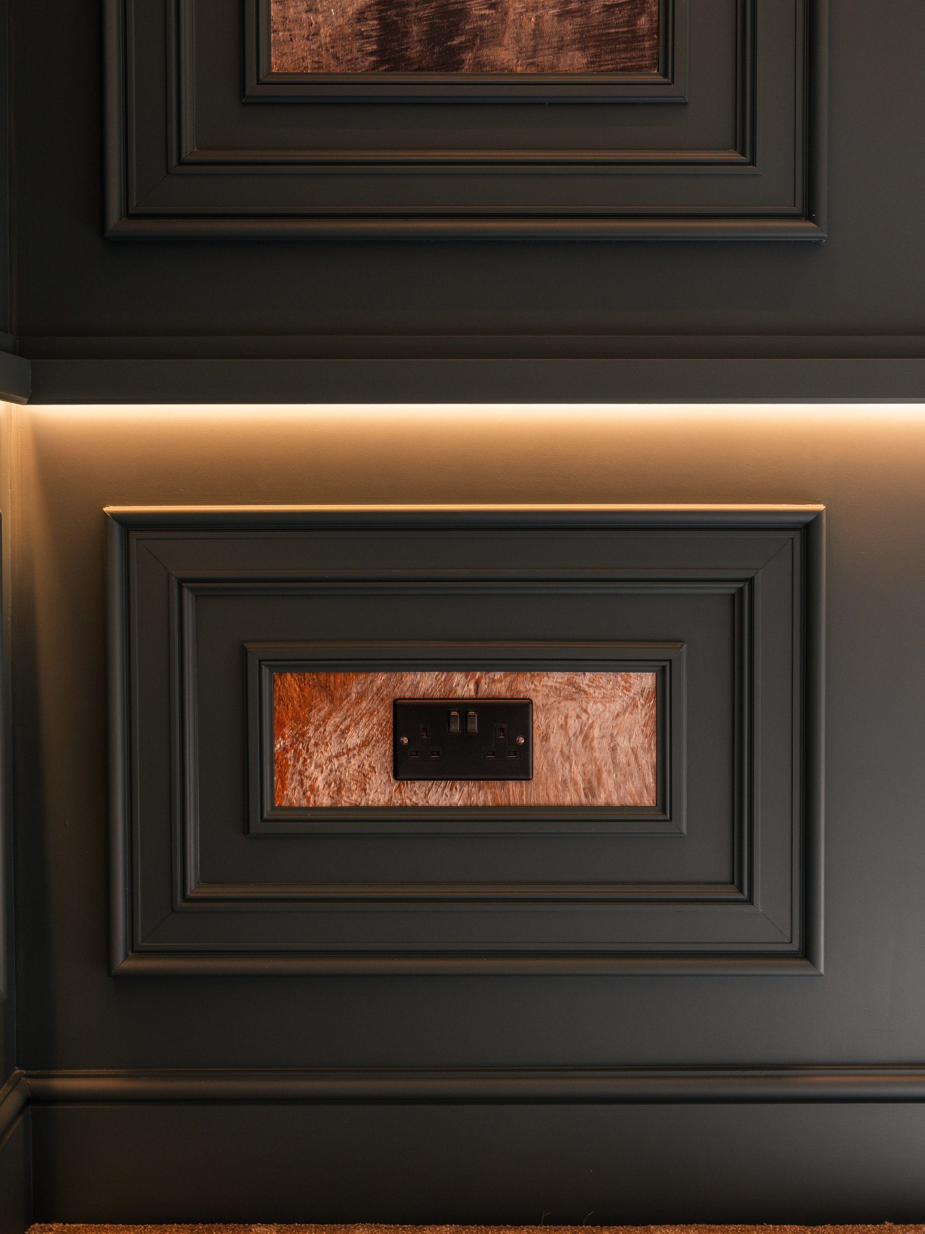 Power socket integrated within copper inset panel — bespoke living room detail by Hafferty Interiors