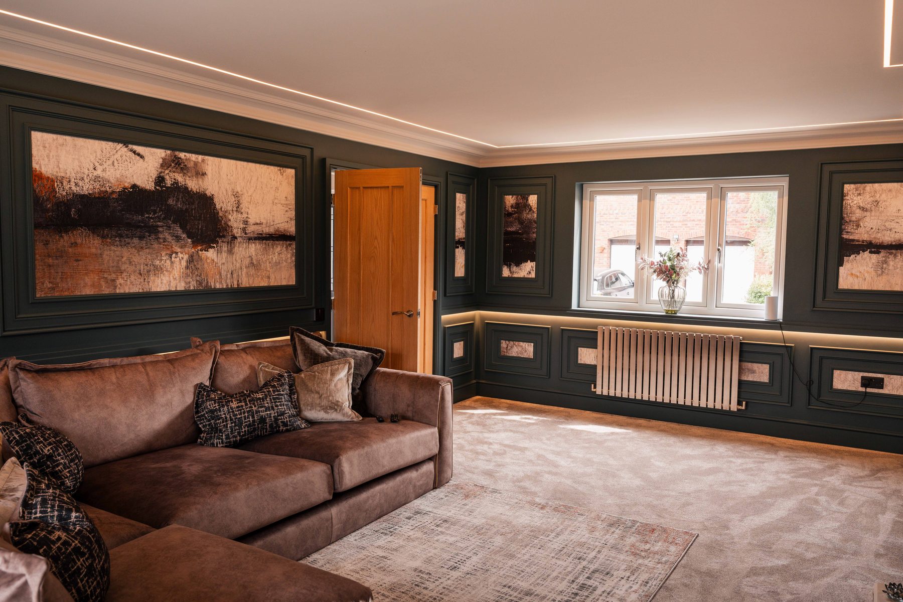 Bespoke dark panelled living room with copper inset detail and LED cove lighting — Hafferty Interiors
