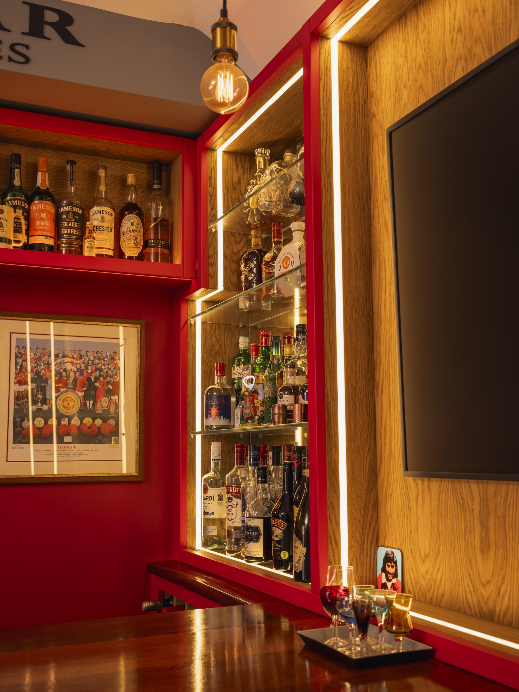 Illuminated display cabinet with LED strip lighting and glass spirit shelves — The Champions Bar by Hafferty Interiors
