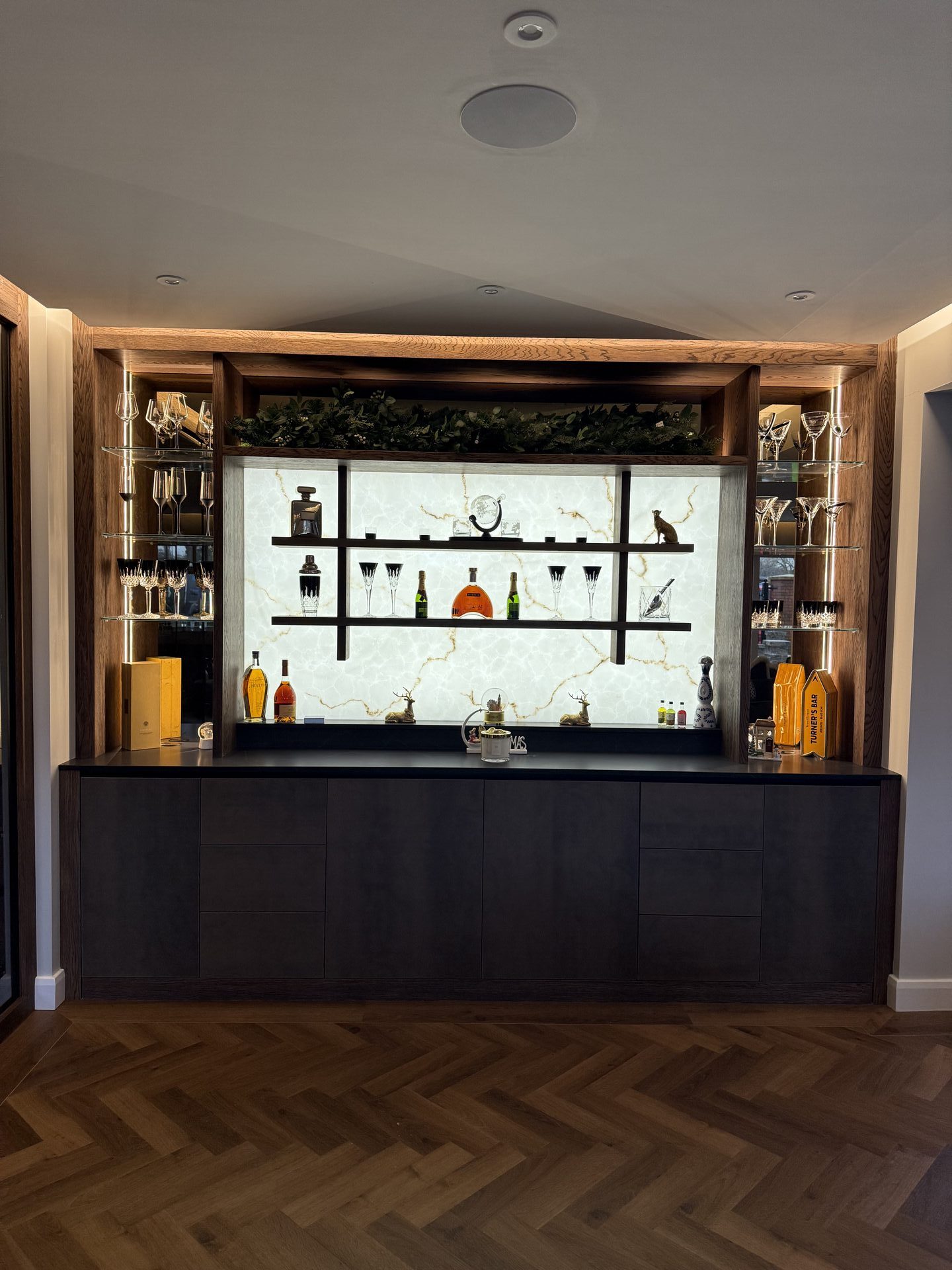 Bespoke hanging back bar design Wilmslow Cheshire — suspended gantry by Hafferty Interiors