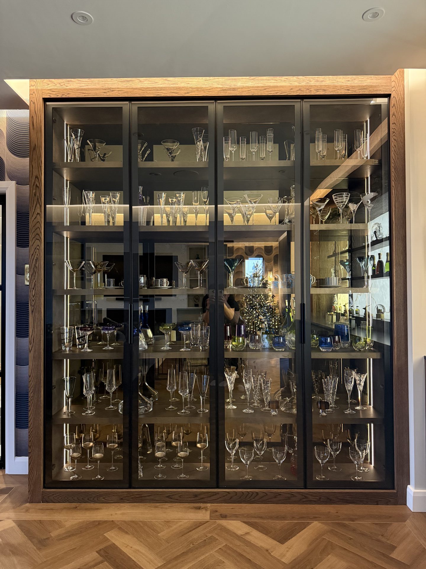 Warm LED smart lighting in chocolate oak cabinetry — fitted home bar Wilmslow by Hafferty Interiors