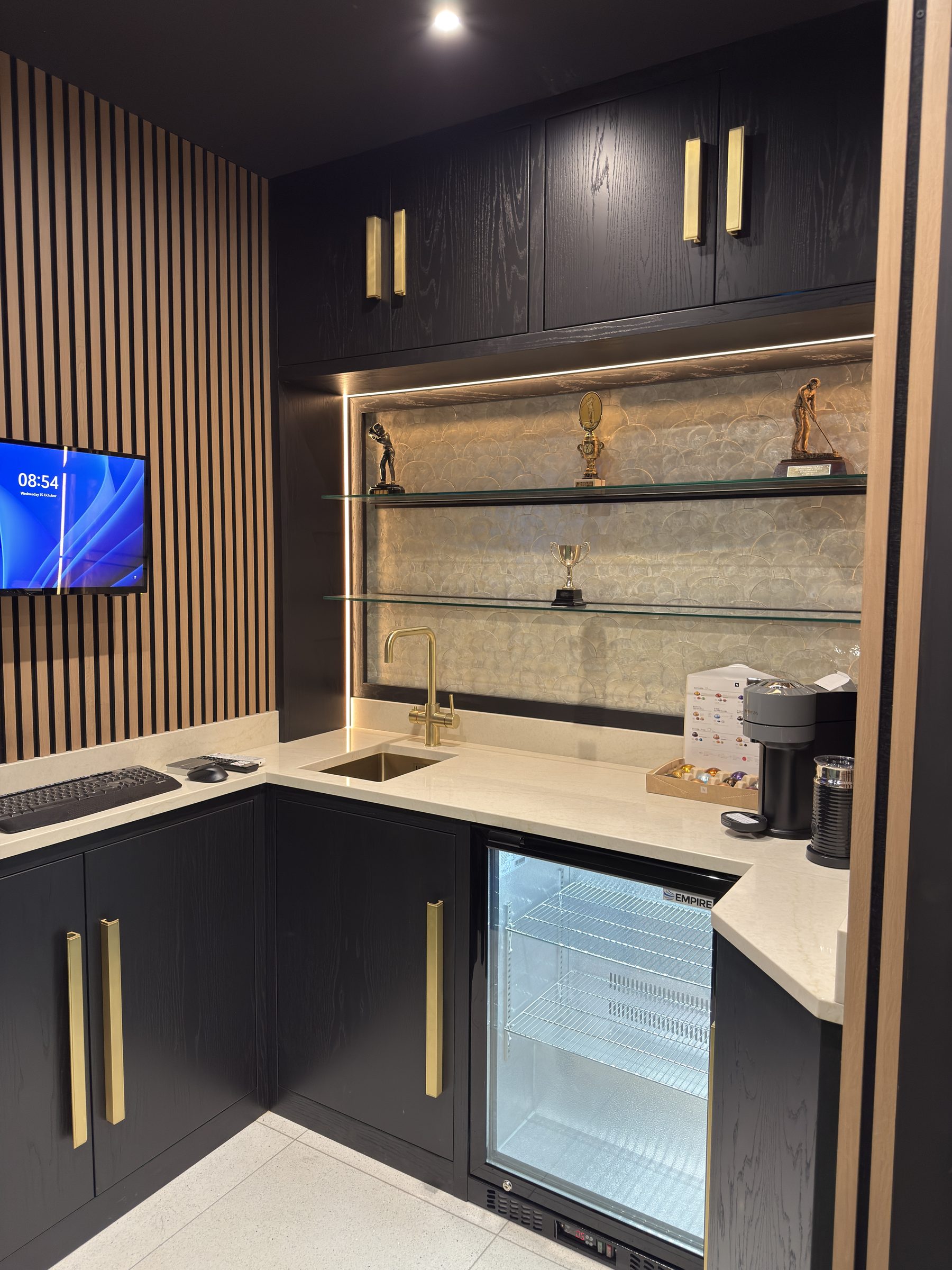 Glass shelves and LED lighting in luxury golf simulator bar Manchester — Hafferty Interiors
