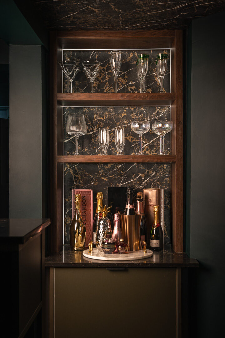 Marble-effect quartz worktop and brushed brass fittings in bespoke home bar Worsley — Hafferty Interiors