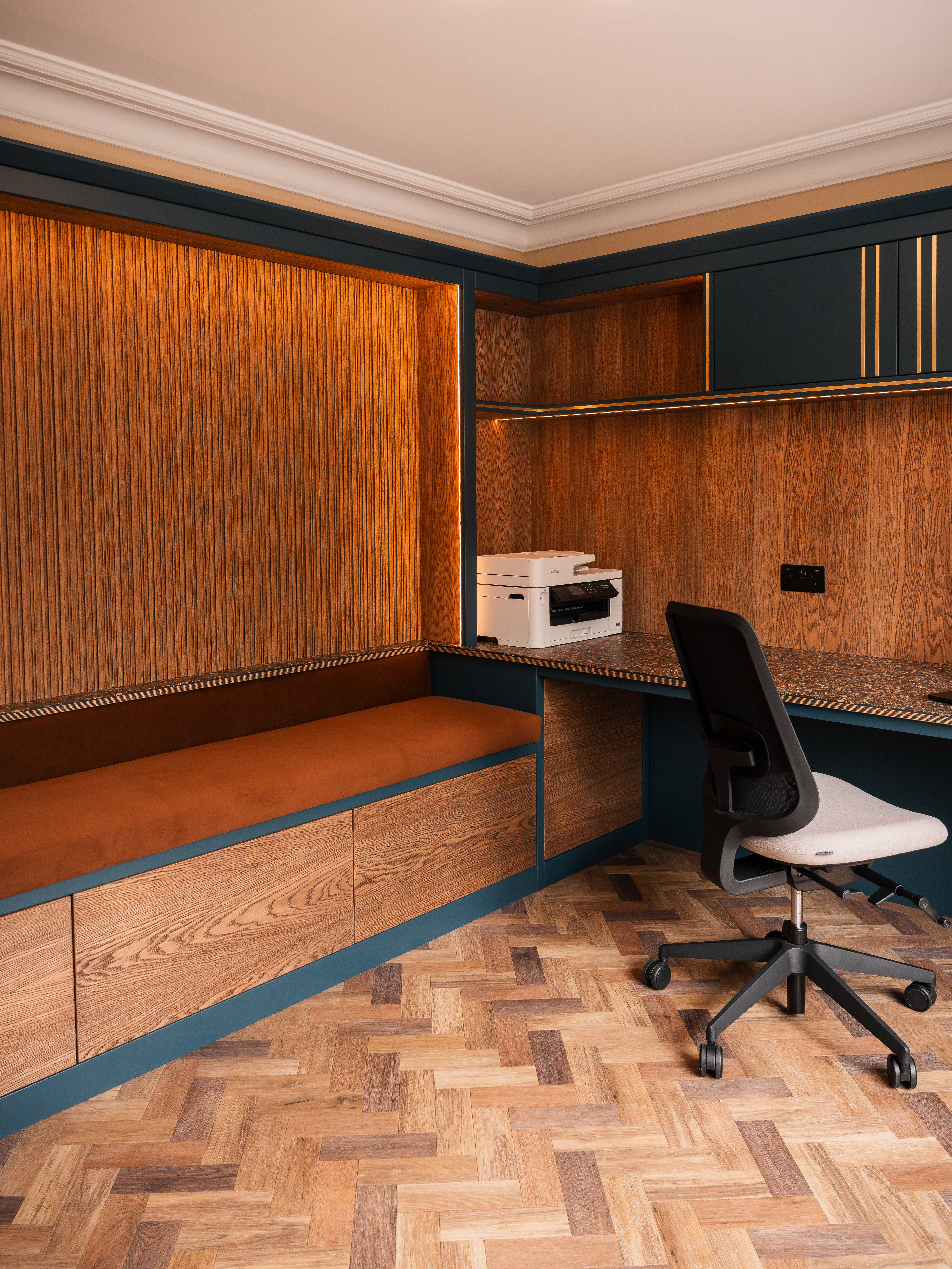 Bespoke home office with teal joinery, velvet bench and herringbone parquet — Boothstown Manchester by Hafferty Interiors