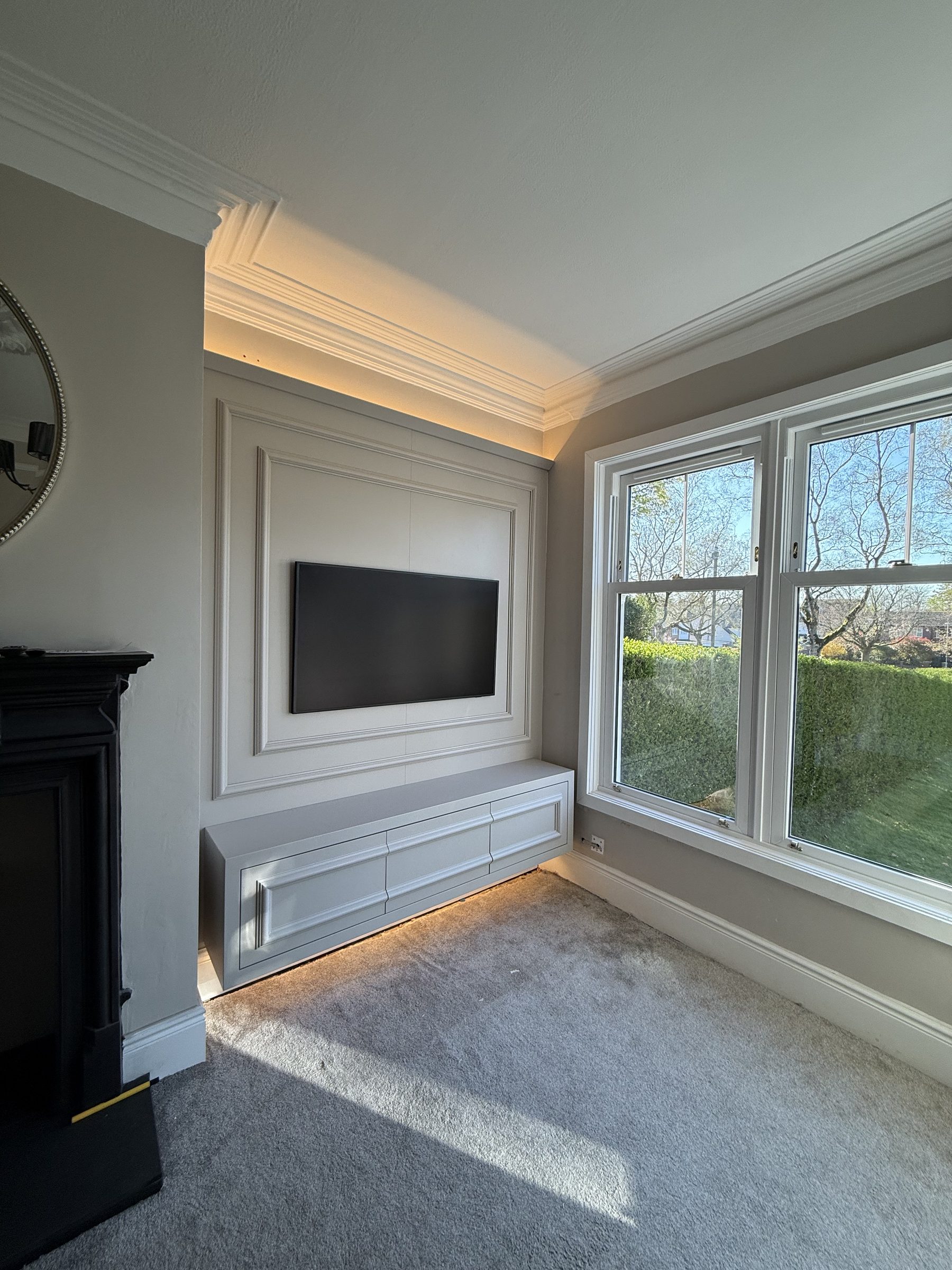 Bespoke fitted media wall and floating drawer unit in period living room with bay window — Hafferty Interiors