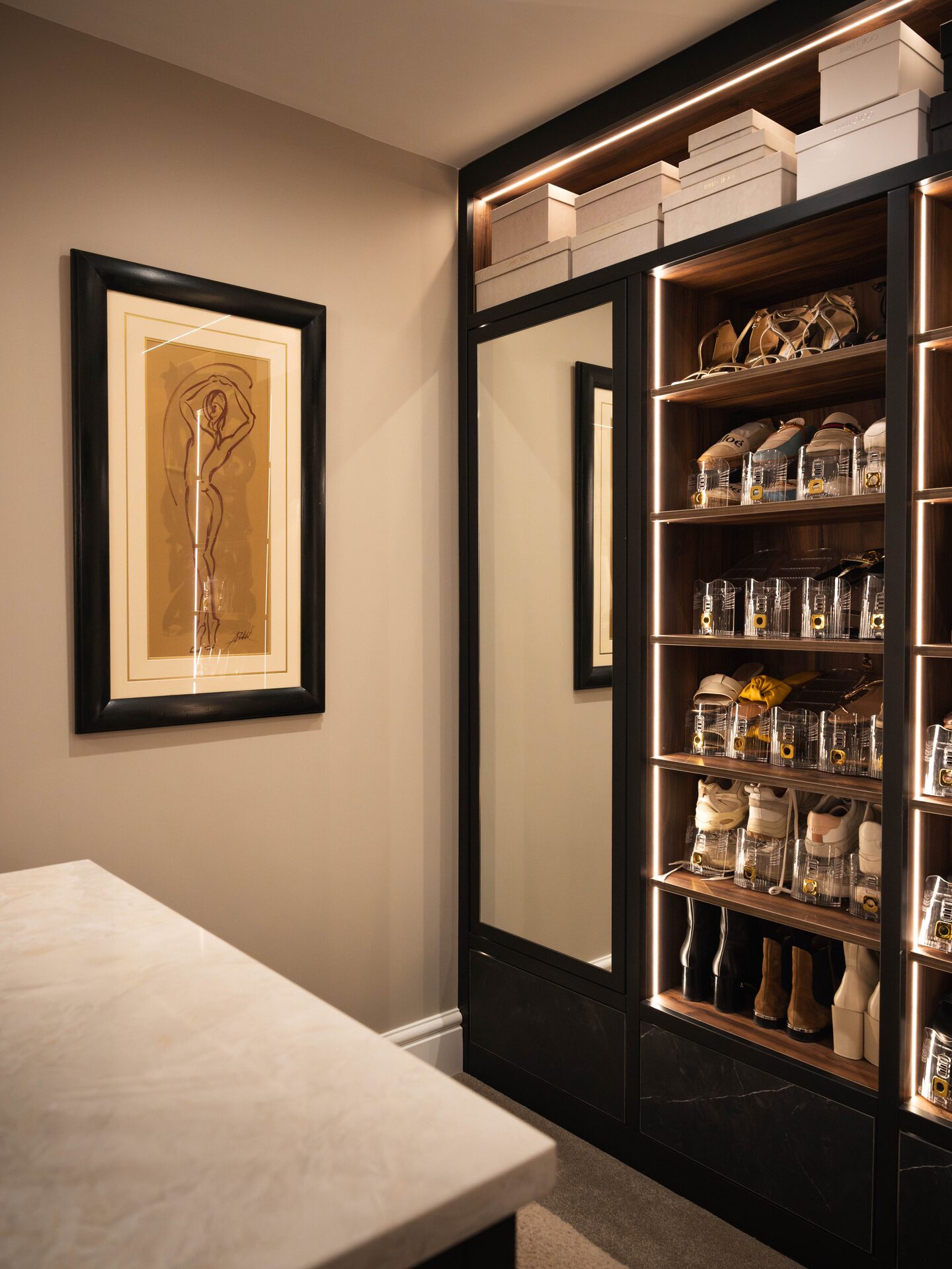 Bespoke mirror artwork framed in walnut joinery — Thompson walk-in wardrobe by Hafferty Interiors Cheshire