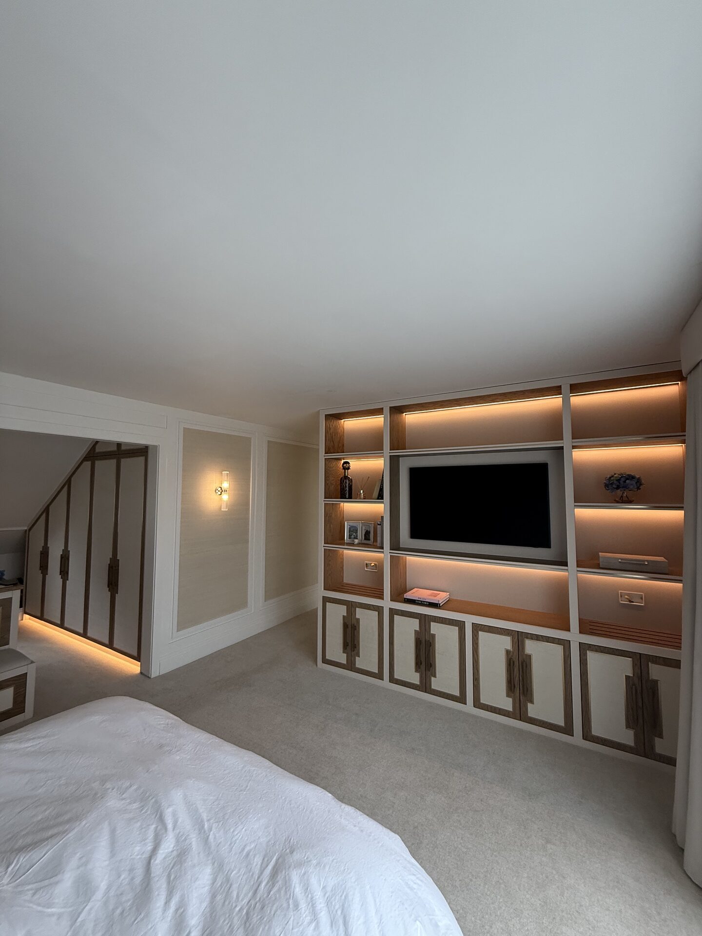 Bespoke media unit integrated into master suite joinery — Hafferty Interiors Manchester
