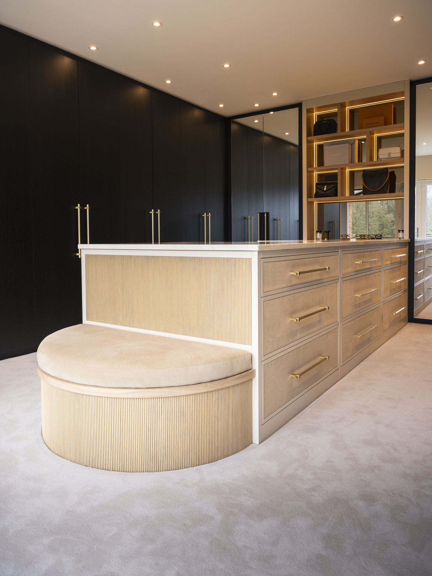 Luxury bespoke walk-in wardrobe Manchester — curved fluted oak island by Hafferty Interiors